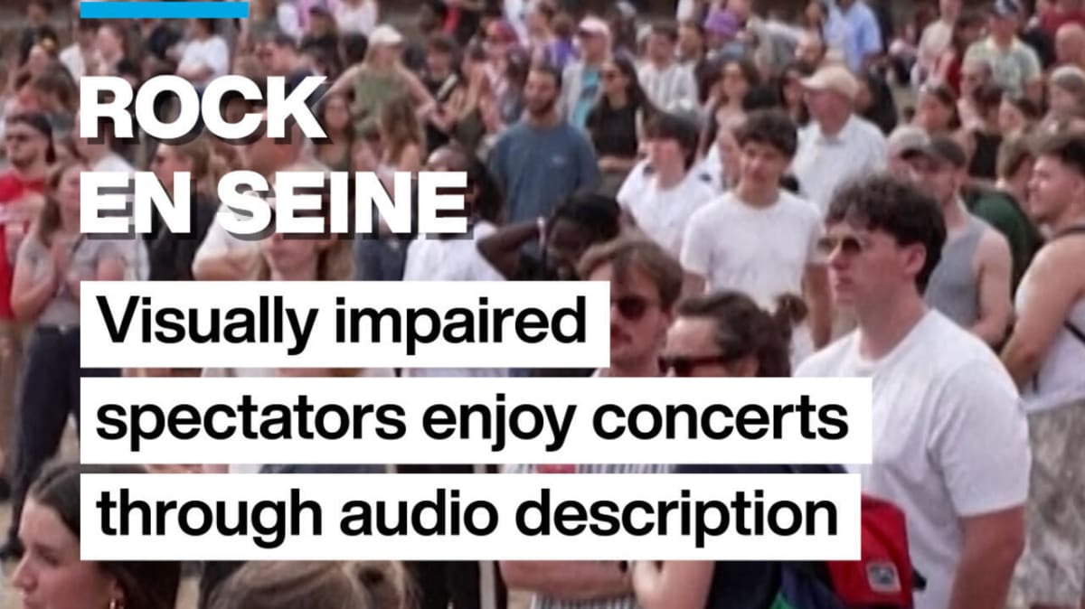 Festival attendee wearing headphones enjoying live music with audio description equipment at Rock en Seine