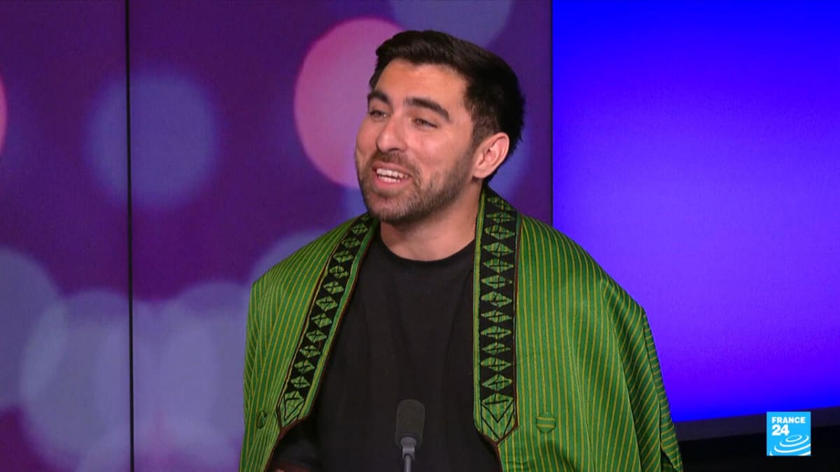 Afghan-American photographer Daniel Malikyar holding camera while working on documentary project