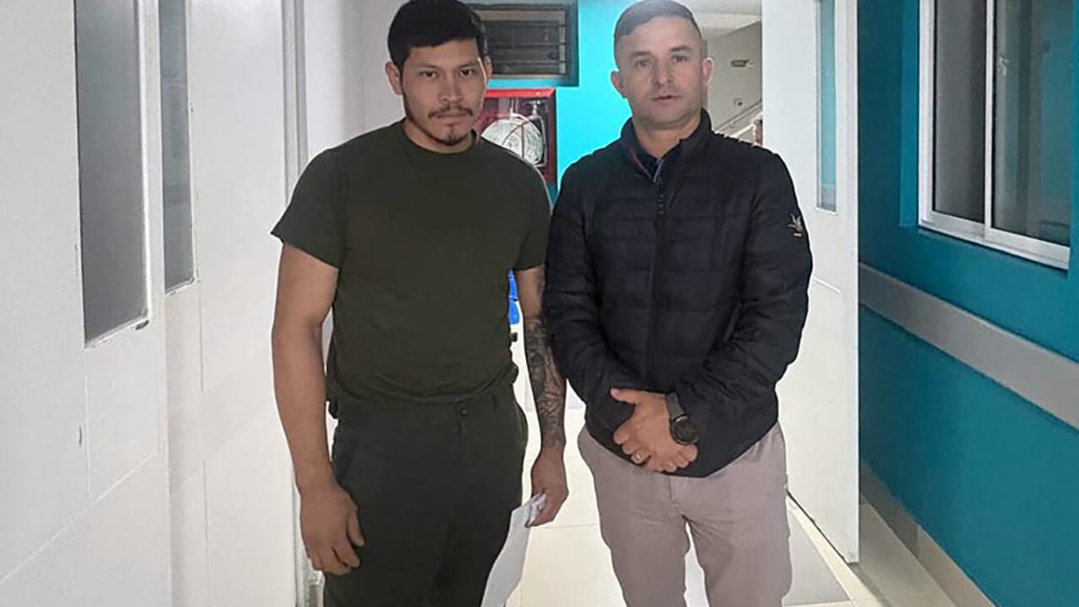 Jose Melo Charry in olive clothing at hospital after escaping Colombian guerrillas
