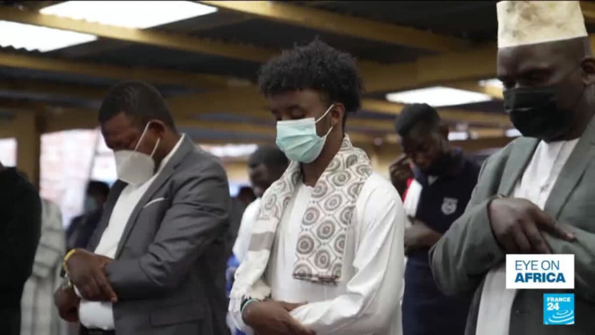 Masked Muslim worshippers gather in small groups for Eid prayers in Bunia, Congo