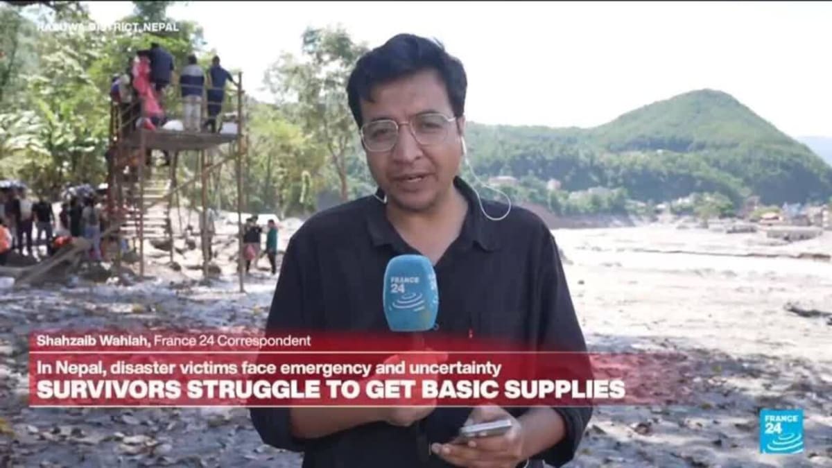 ** Rescue workers in Nepal celebrating after finding survivors in flood disaster zone