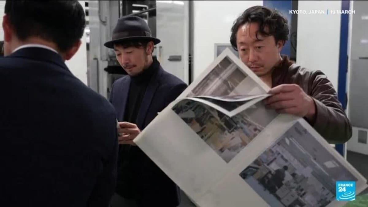 Traditional printing press machinery producing colorful independent zines in Japanese newspaper facility
