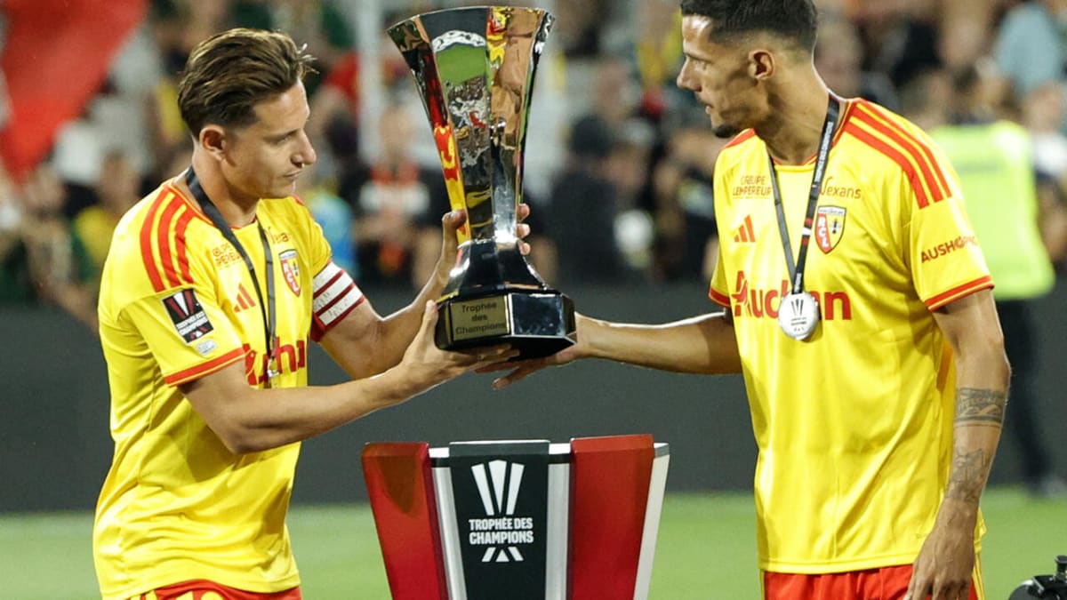 Lens players Florian Thauvin and Florian Sotoca celebrating with French Super Cup trophy