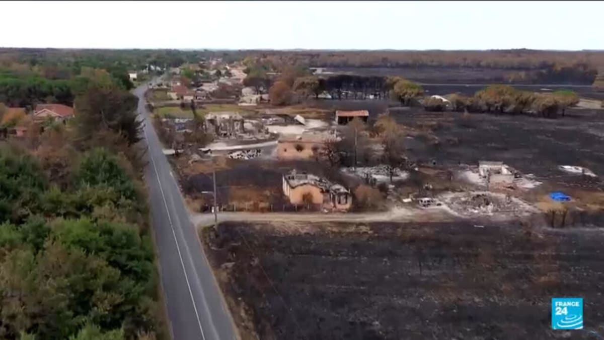 French firefighters monitoring controlled wildfire area in Gironde region with equipment and vehicles