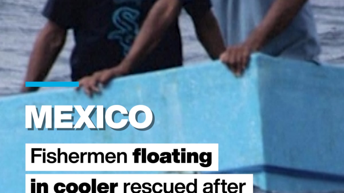 Mexican Navy rescue team pulling two fishermen from Pacific Ocean waters onto rescue vessel