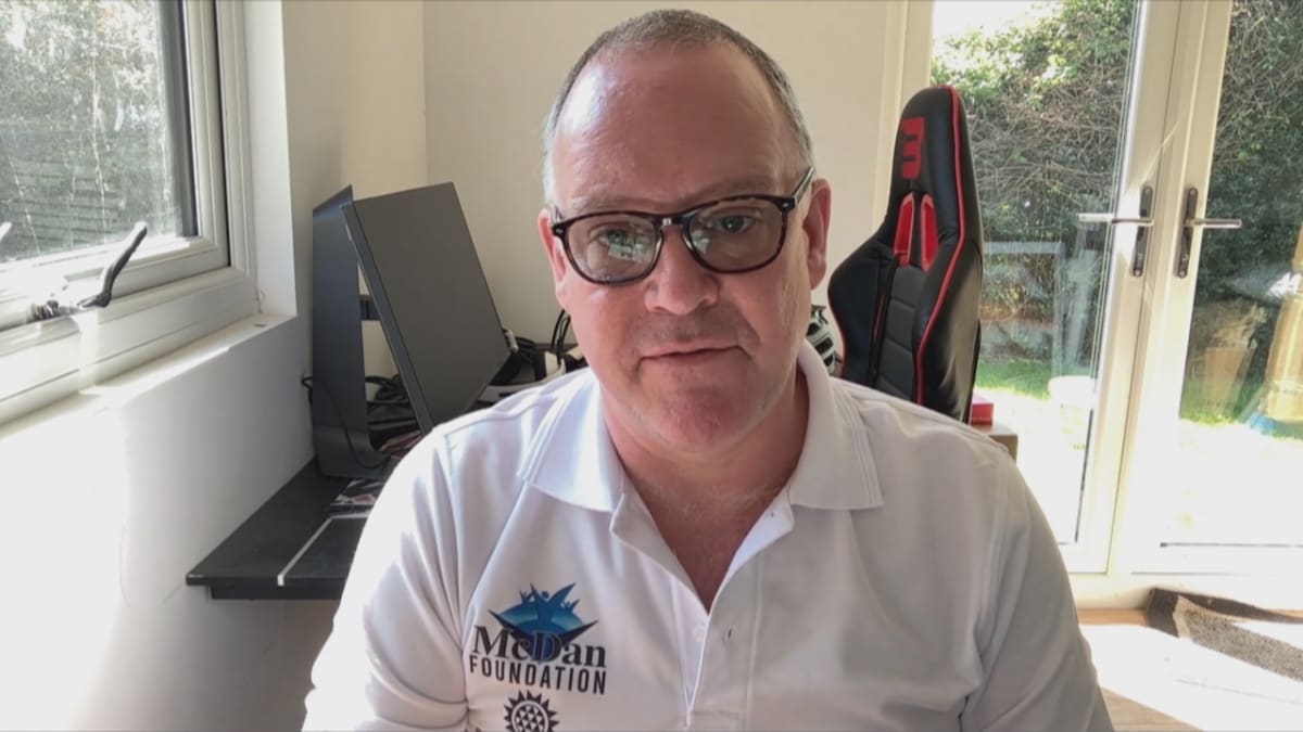 Ukrainian farmers loading grain onto trucks for humanitarian food distribution program