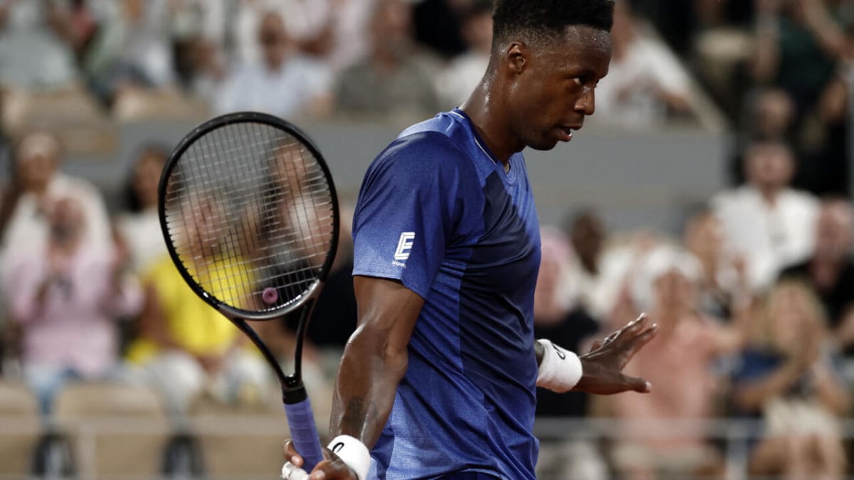 Gaël Monfils waves to cheering crowd at Roland Garros during emotional farewell ceremony