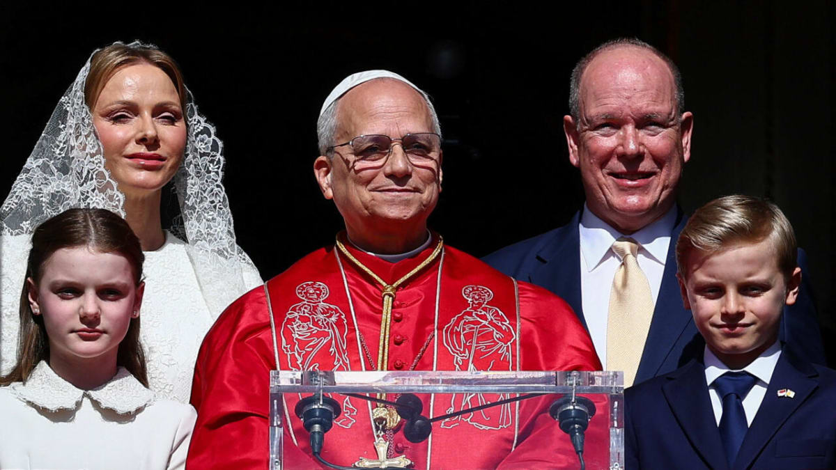 ** Pope Leo XIV waves from Prince's Palace balcony with Monaco's royal family overlooking Monte Carlo