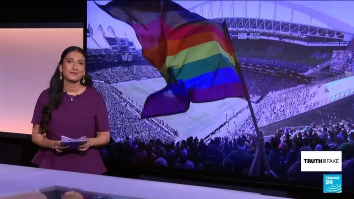 Rainbow Pride flag waving outside soccer stadium during World Cup 2026 match day