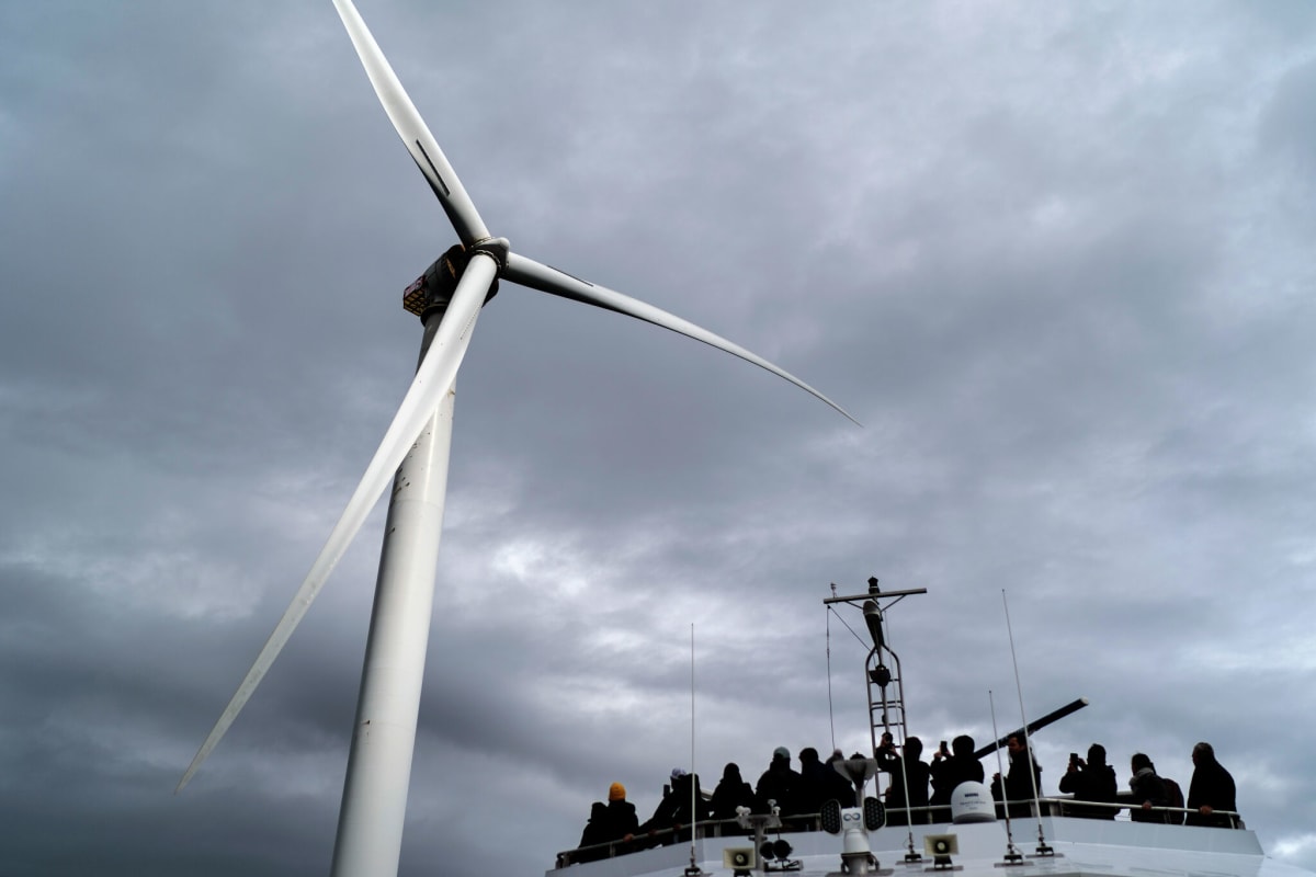 Offshore wind turbines rise from calm Gulf waters near Texas coast during sunset