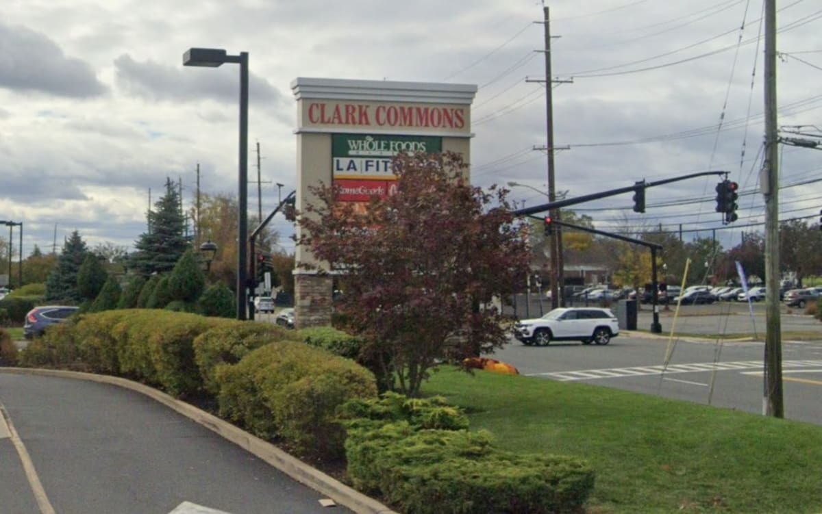 Police officers caring for Koko, a reunited dog, inside Clark New Jersey police station dispatch room