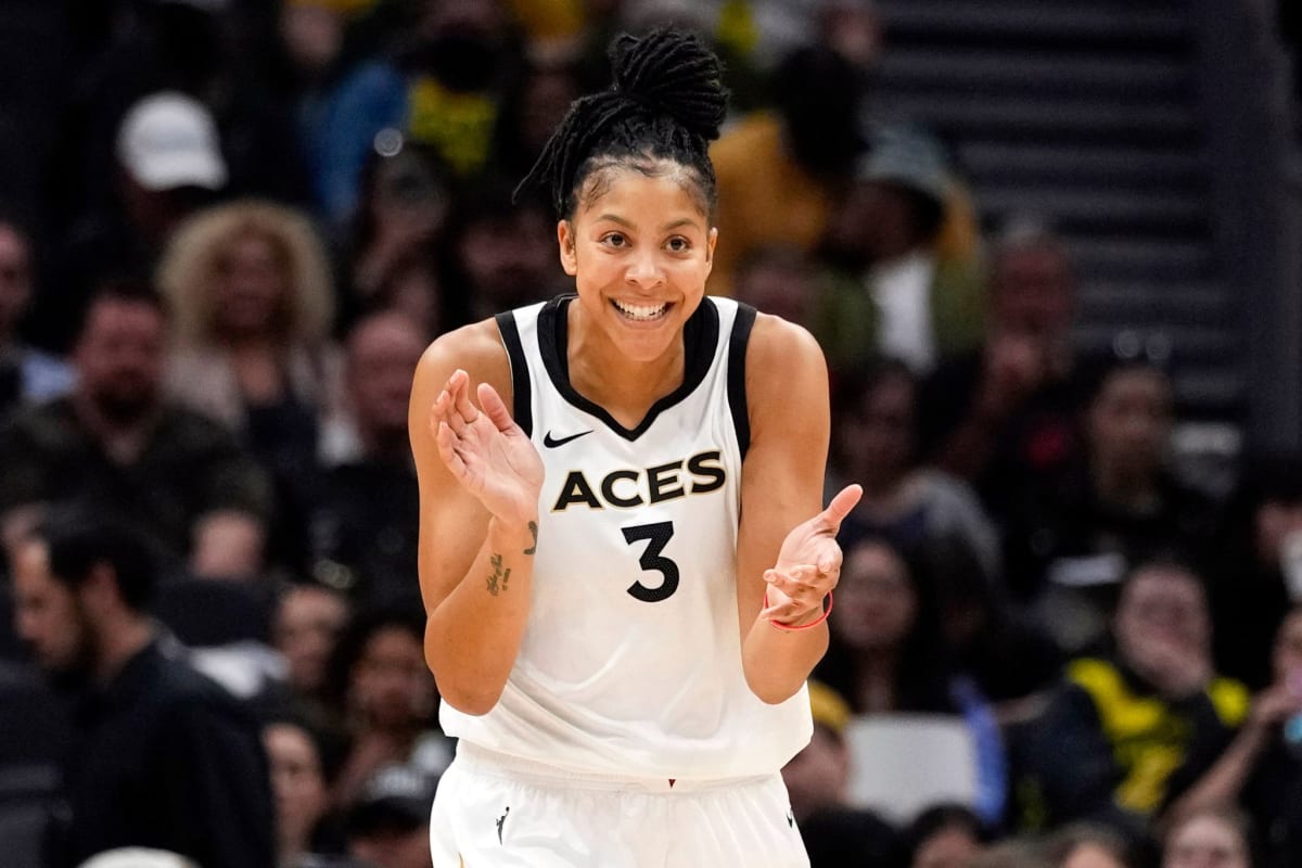 Candace Parker celebrating during WNBA game wearing her team jersey and smiling