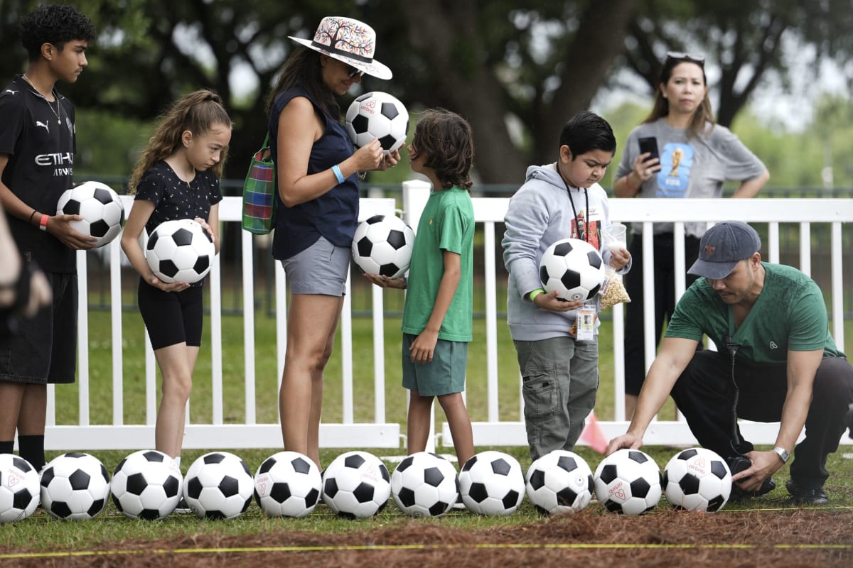 Hundreds of soccer balls lined up in winding formation at Houston's Hermann Park