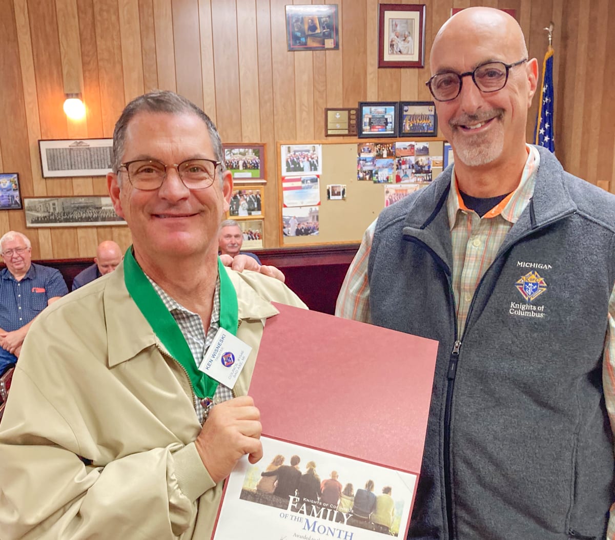 Knights of Columbus Grand Knight presenting award certificate to community member in formal setting