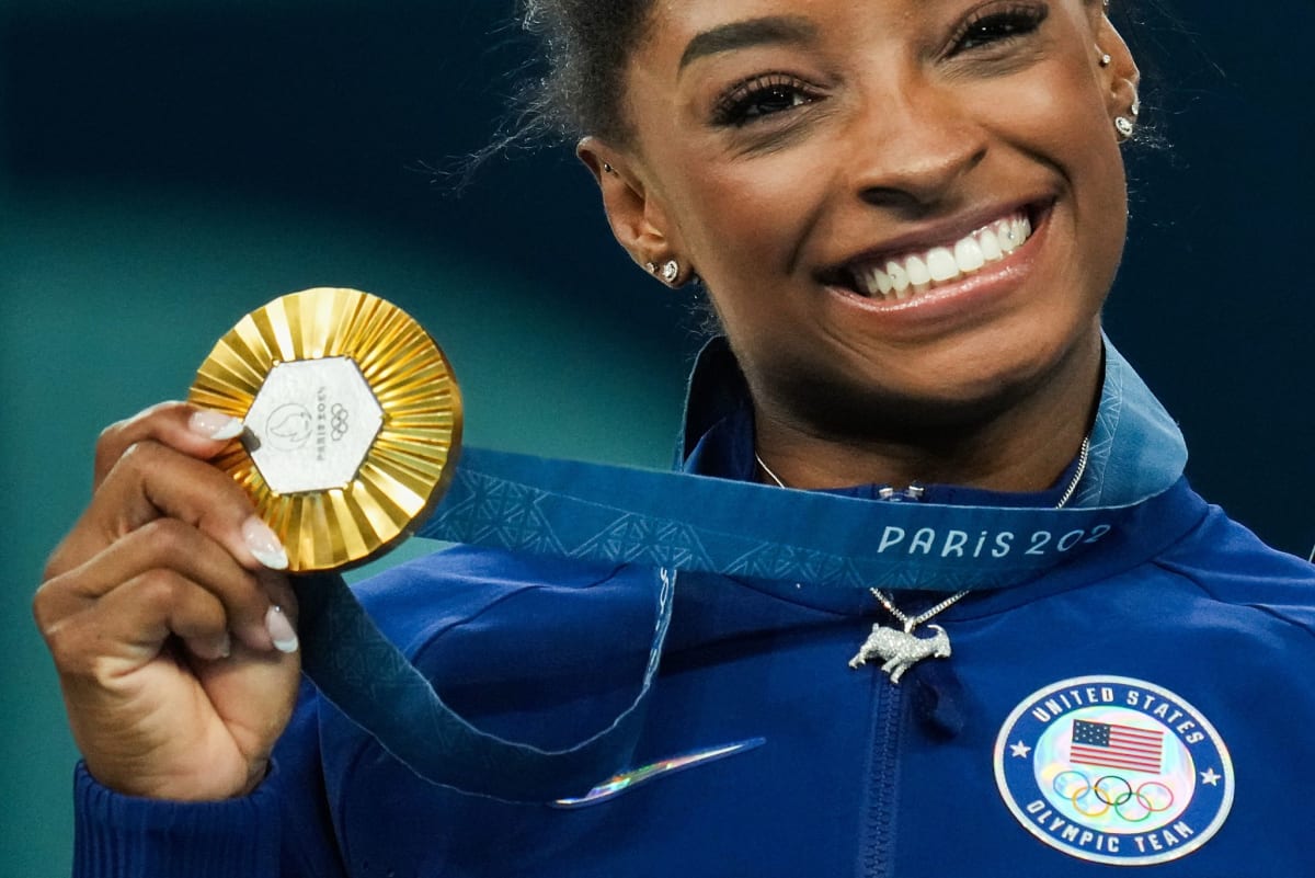 Simone Biles celebrates with gold medal at 2024 Paris Olympics women's gymnastics all-around final