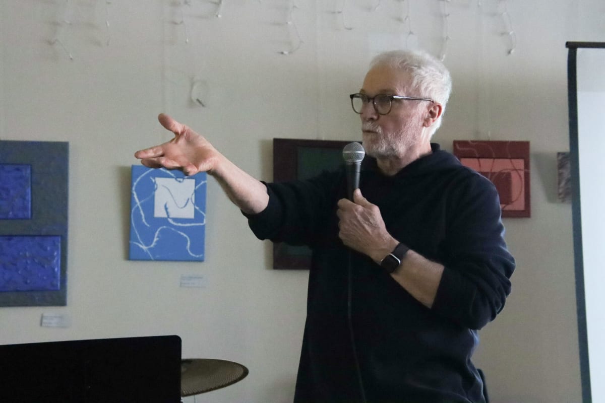 Climate expert Peter Sinclair presenting renewable energy benefits to packed audience at Michigan coffee shop