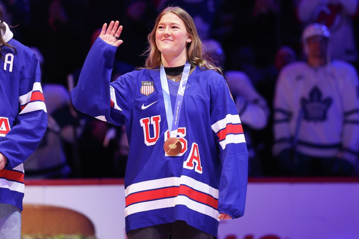 Olympic gold medalist Haley Winn waves to hockey fans from ice rink in Newark