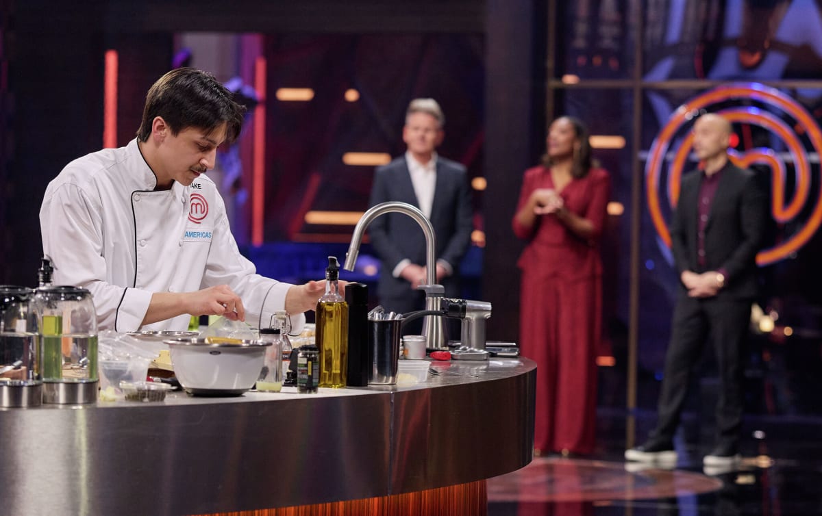 Jake Kelley holding MasterChef trophy and smiling after winning cooking competition championship