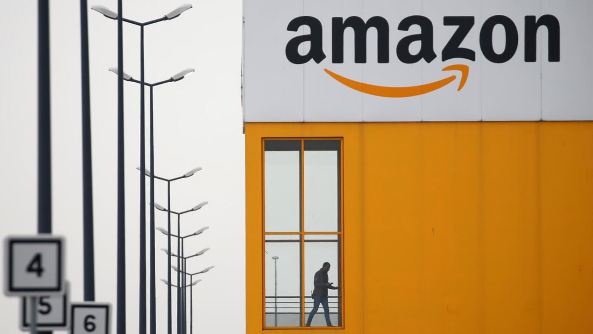 Amazon distribution center exterior with French flag, representing major job creation investment