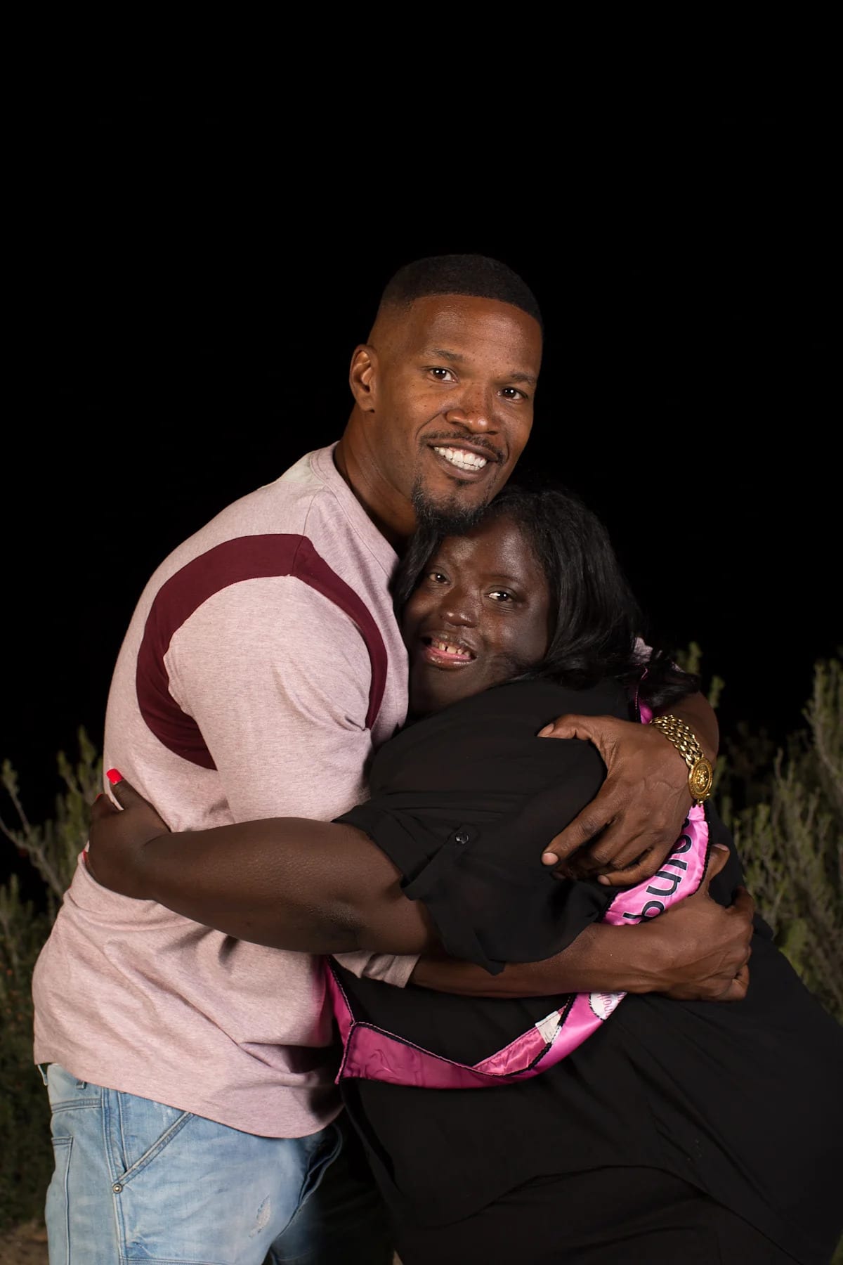 DeOndra Dixon smiling alongside her brother Jamie Foxx at advocacy event