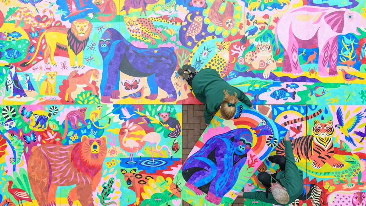 Visitors painting colorful animals on massive paint-by-numbers boards at London Zoo