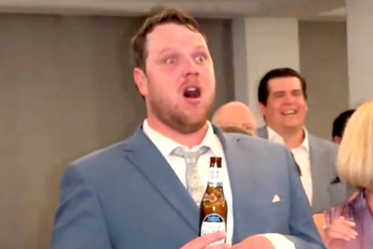 Groom Max Creamer looks shocked during wedding reception father-daughter dance surprise moment