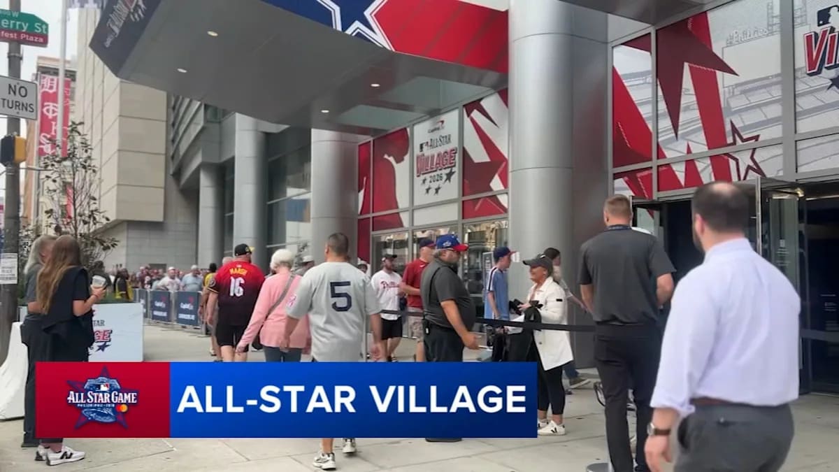 Young boy in baseball jersey smiling at Philadelphia's MLB All-Star Village interactive exhibit