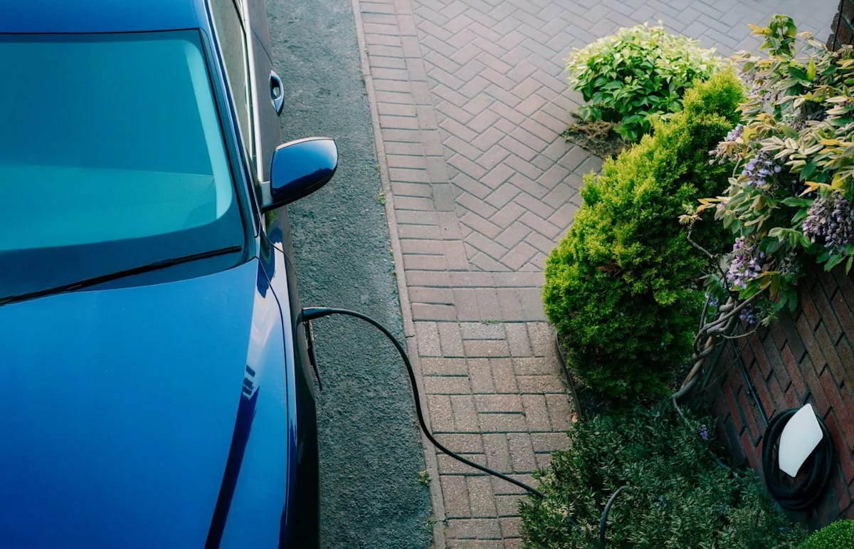 Electric vehicle charging at home station with renewable energy powering the connection