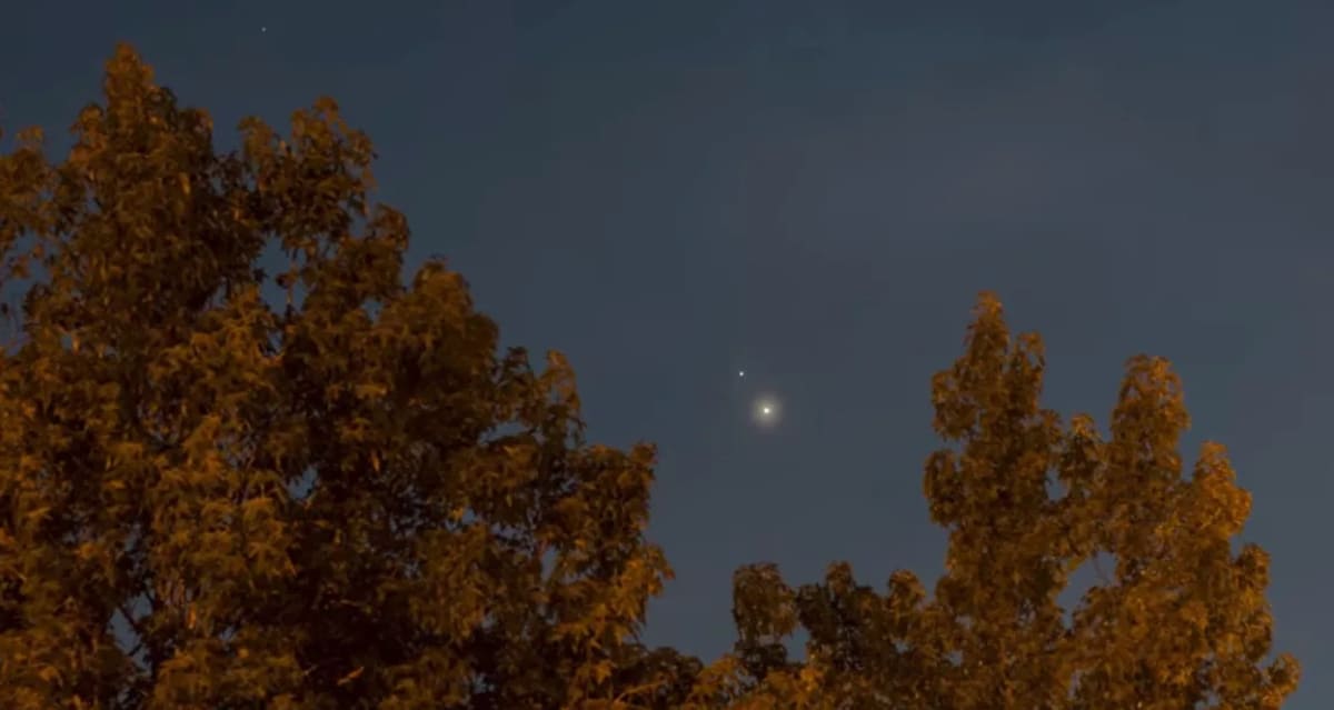 Three bright planets Mercury Venus and Jupiter aligned together in dark night sky