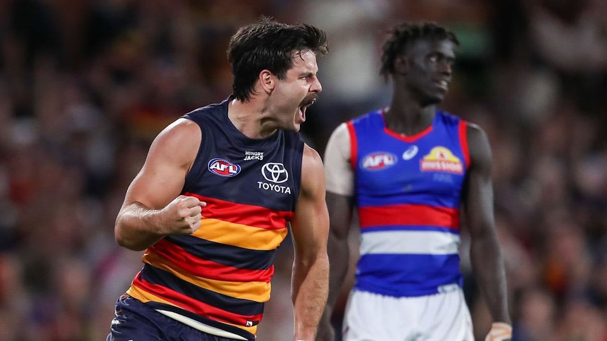 Adelaide Crows players celebrating their elimination finals victory at Adelaide Oval with enthusiastic crowd
