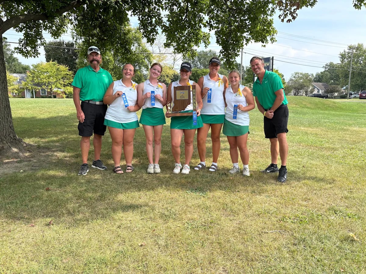 High school girls golf team celebrating sectional championship victory with coaches and trophy