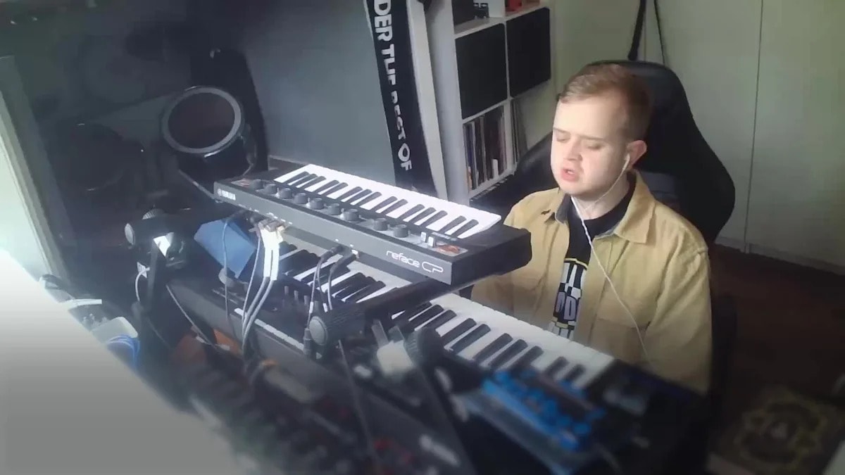 Young musician Louis performing or creating music despite being blind and partially deaf from childhood cancer