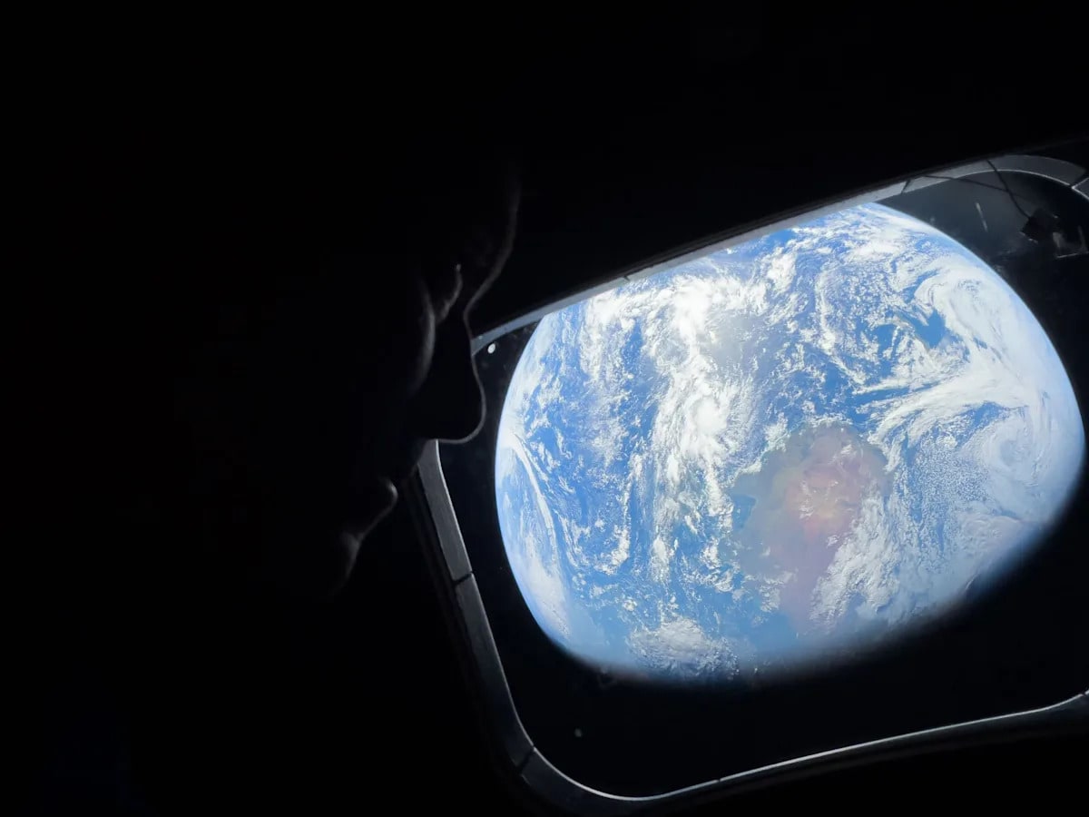 Artemis II Commander Reid Wiseman looks at Earth through Orion spacecraft window during historic lunar mission
