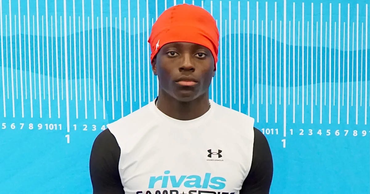 High school football player Darnell Jackson in uniform celebrating his commitment to University of Utah