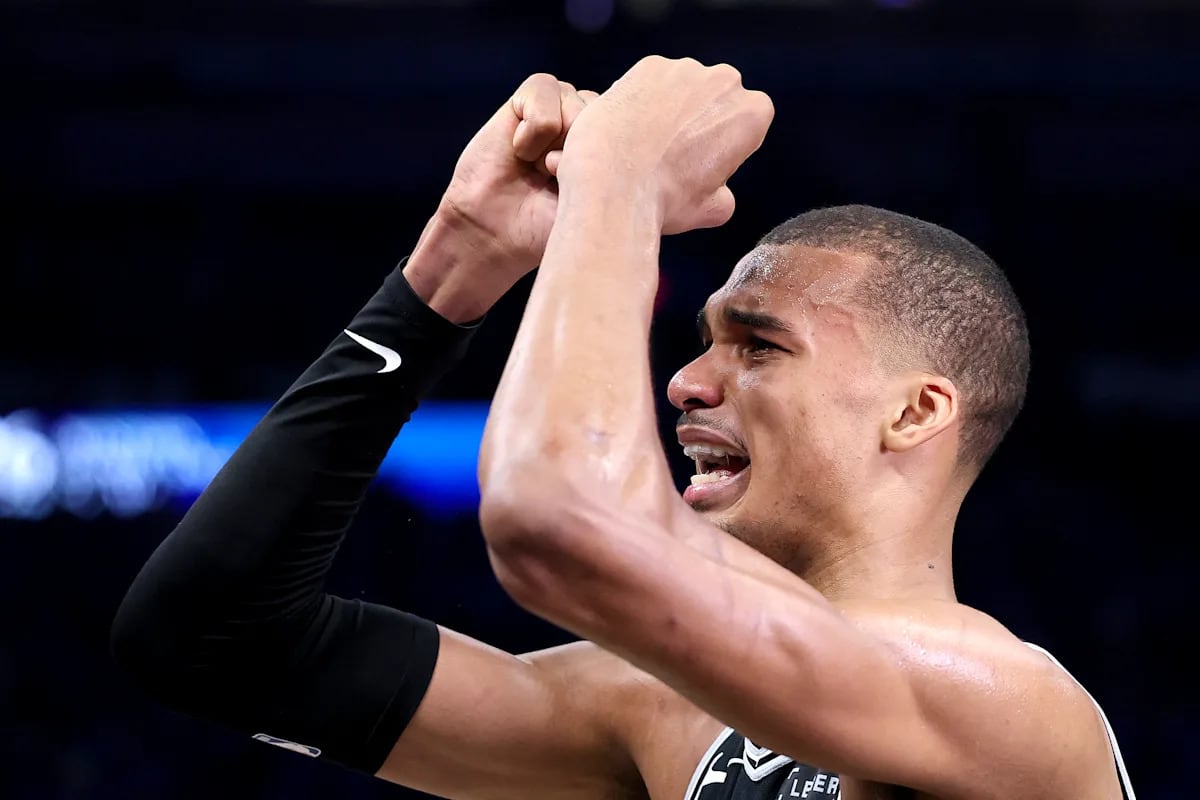 San Antonio Spurs fans celebrating in crowded streets with fireworks overhead at night