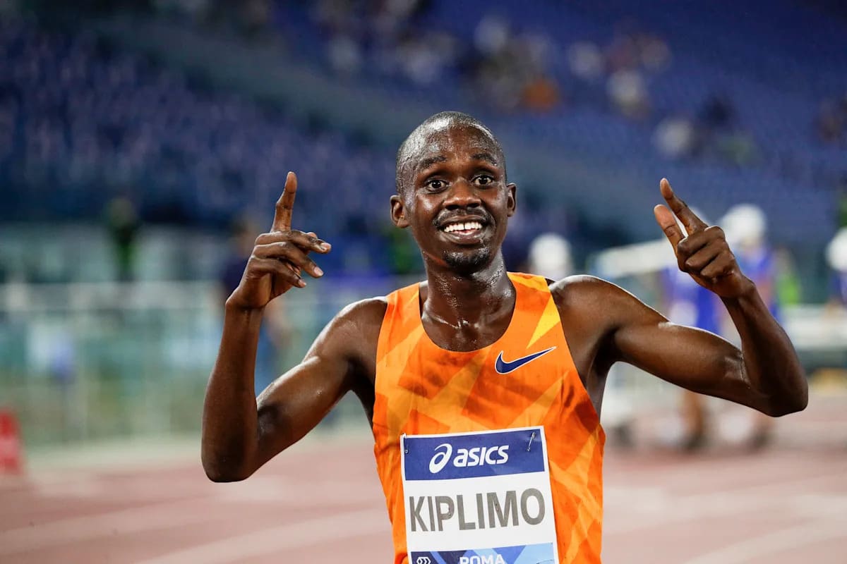 Jacob Kiplimo racing in competition, celebrating his half marathon world record achievement