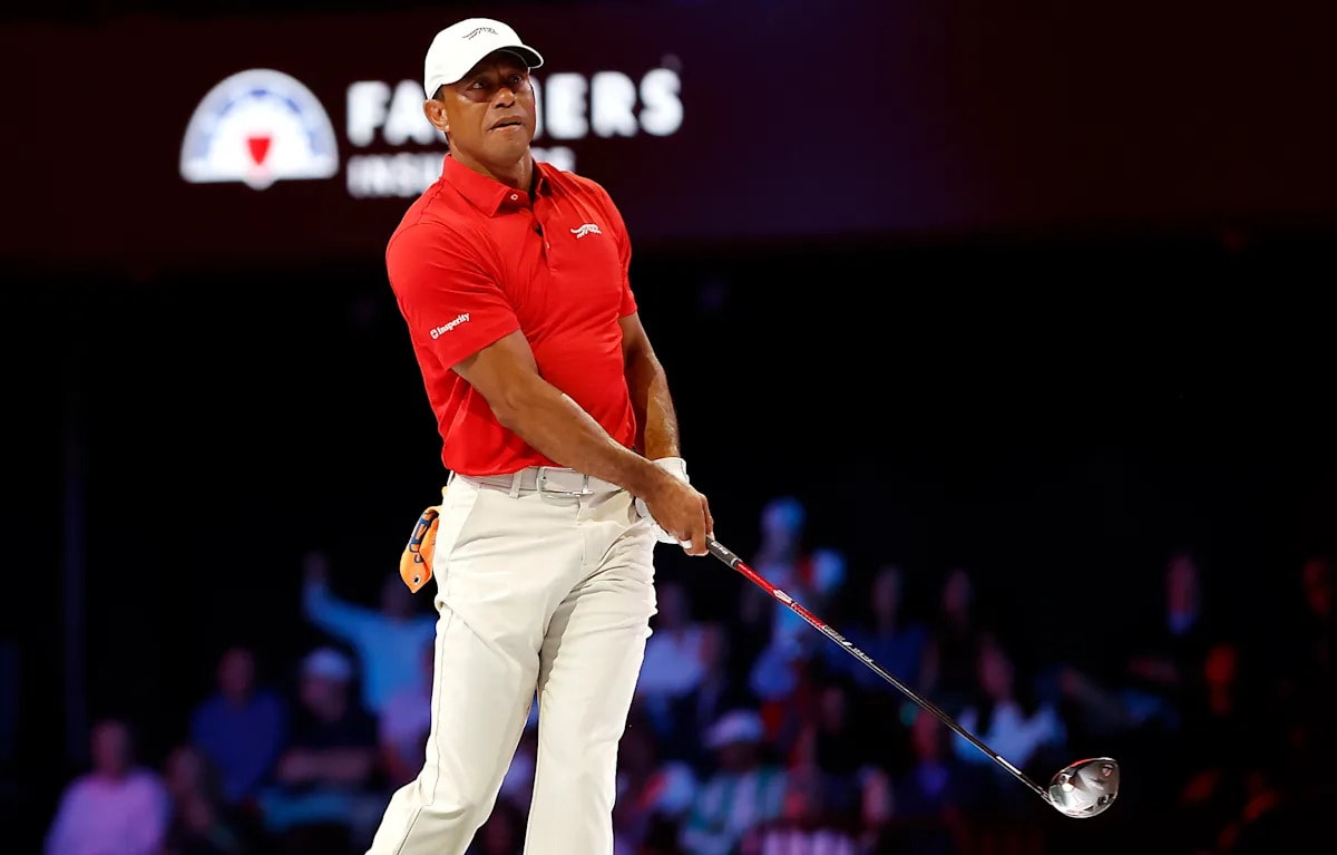 Tiger Woods swinging golf club during indoor TGL championship match return after year recovery