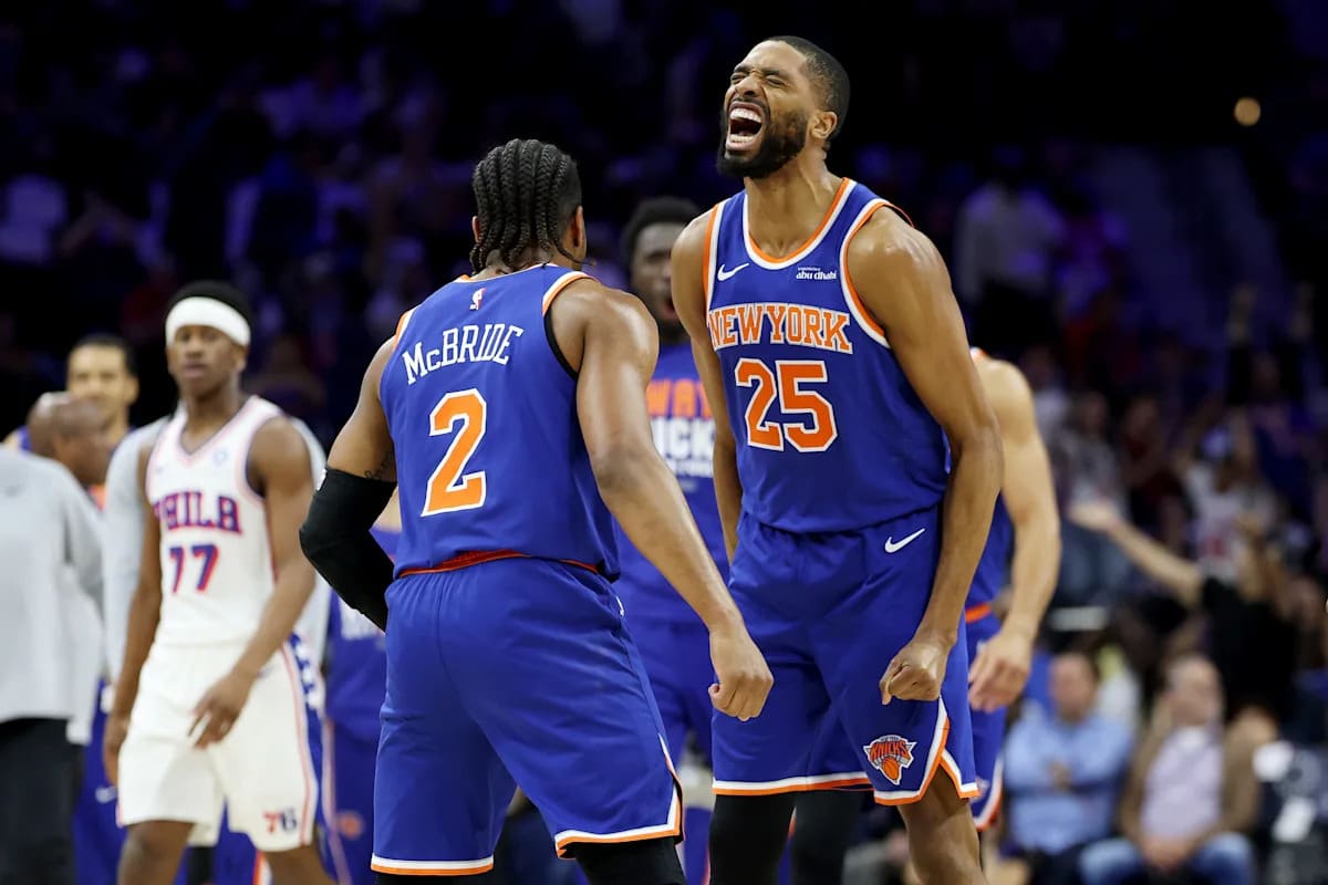 New York Knicks players celebrating on court after record-setting three-point shooting performance in playoff victory