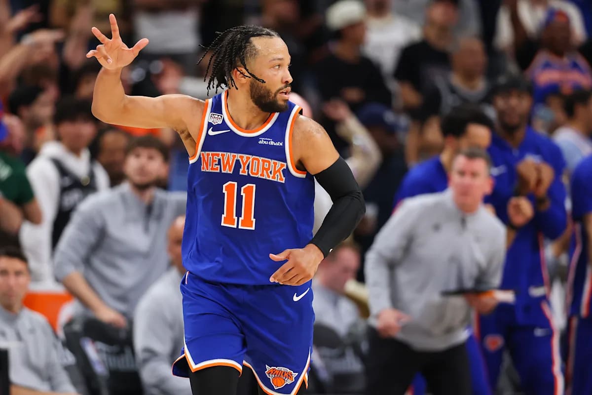 New York Knicks players celebrating their 2026 NBA championship victory on court with trophy
