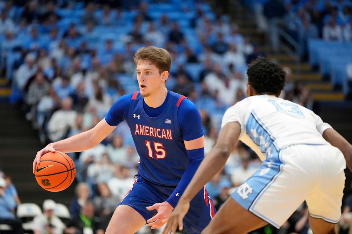 Basketball player Matt Rogers shooting a jump shot in Philadelphia 76ers summer league uniform