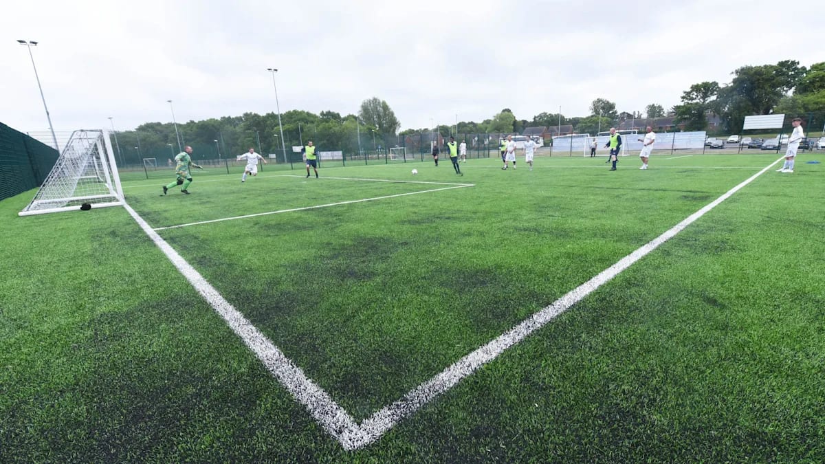 Football players competing during Homeless World Cup trials at outdoor facility in Middlesbrough