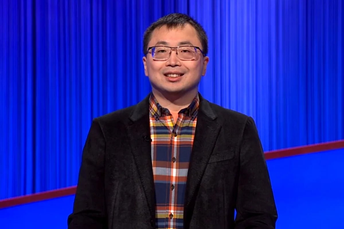 Jamie Ding standing at Jeopardy podium smiling during his record-breaking winning streak