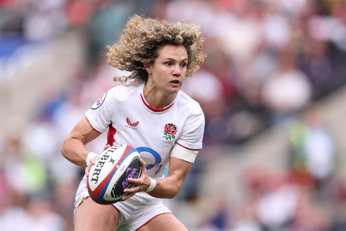 England rugby player Ellie Kildunne in red jersey celebrating during World Cup match