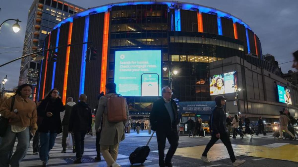 New York Knicks celebrating NBA championship victory with fans in crowded arena