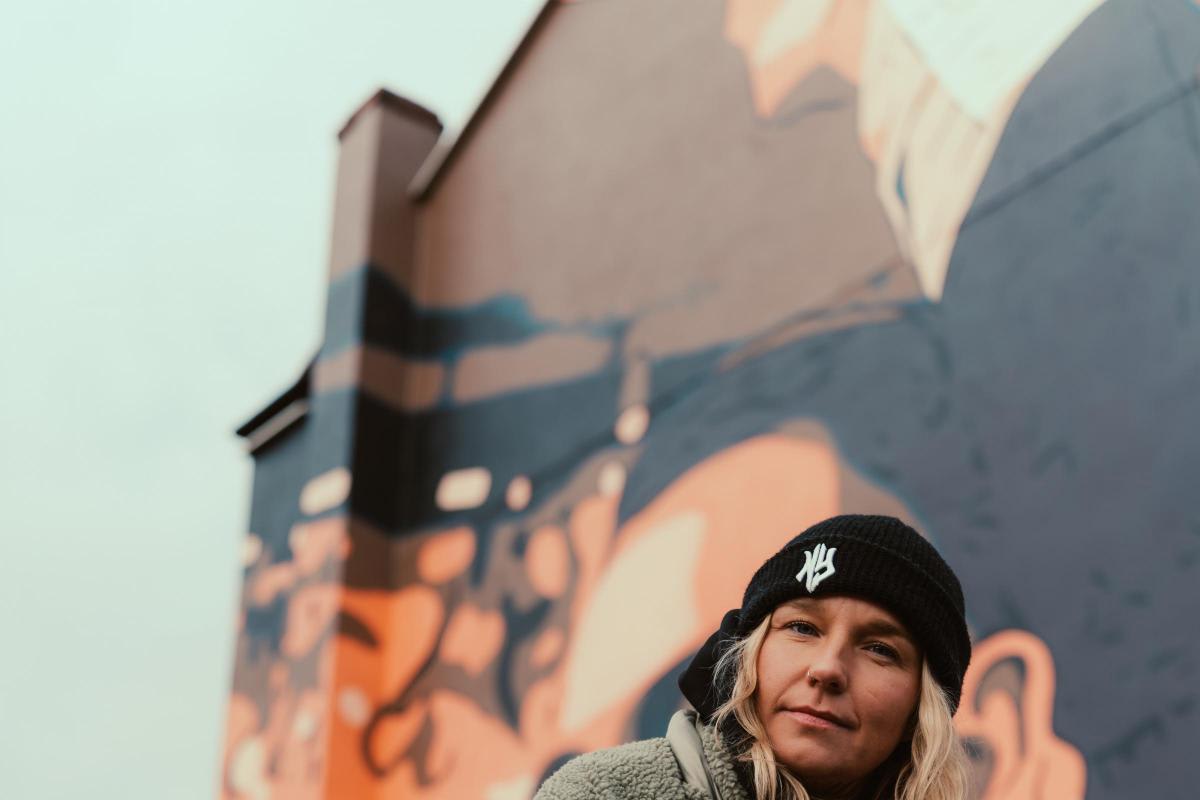 Domi, former wrestling champion and recovery advocate, smiling confidently in Warrington community setting