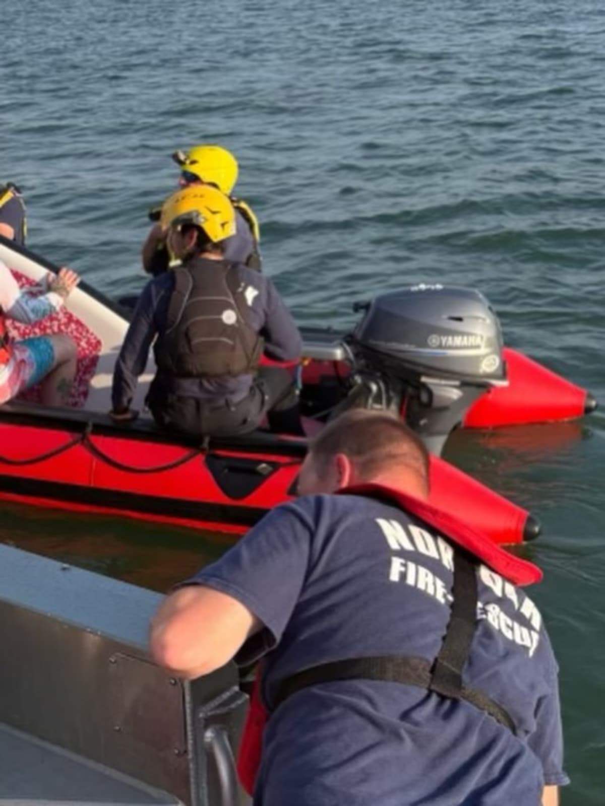 Norfolk Fire-Rescue boat on water during paddleboarder rescue operation near Ocean View Pier