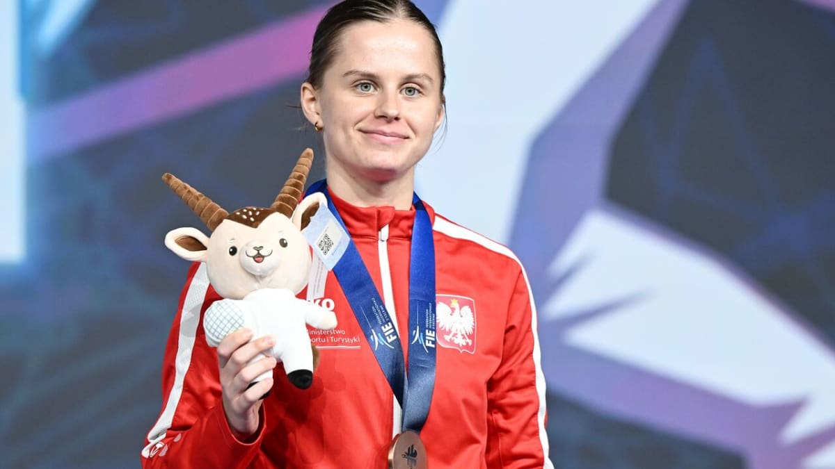 Barbara Brych celebrating with bronze medal at World Fencing Championships in Hong Kong