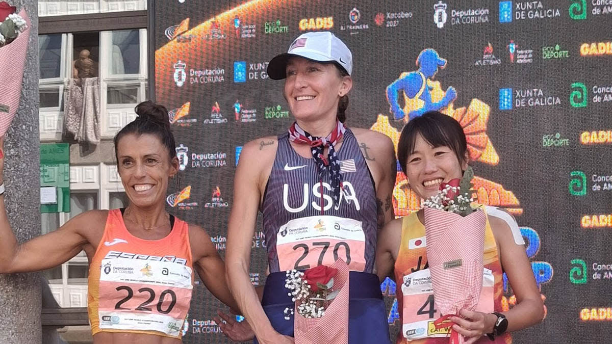 Courtney Olsen crossing finish line at 100K World Championships in Spain wearing American colors