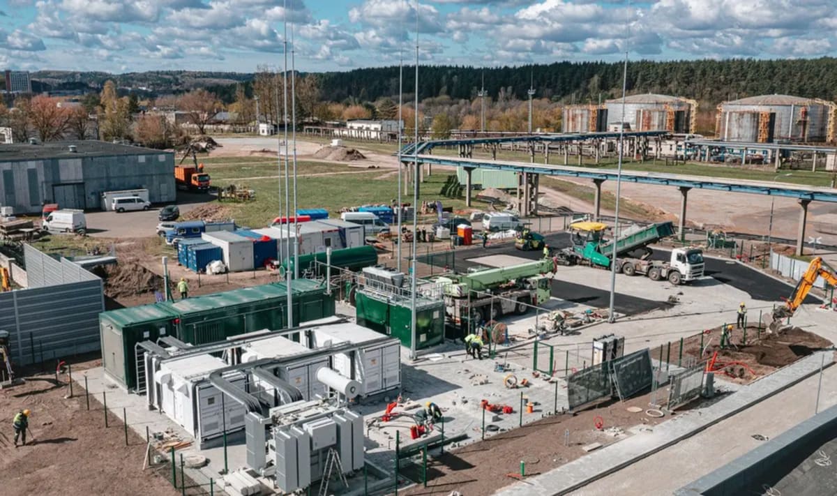 Modern green hydrogen production facility with large industrial equipment and storage tanks in Vilnius, Lithuania