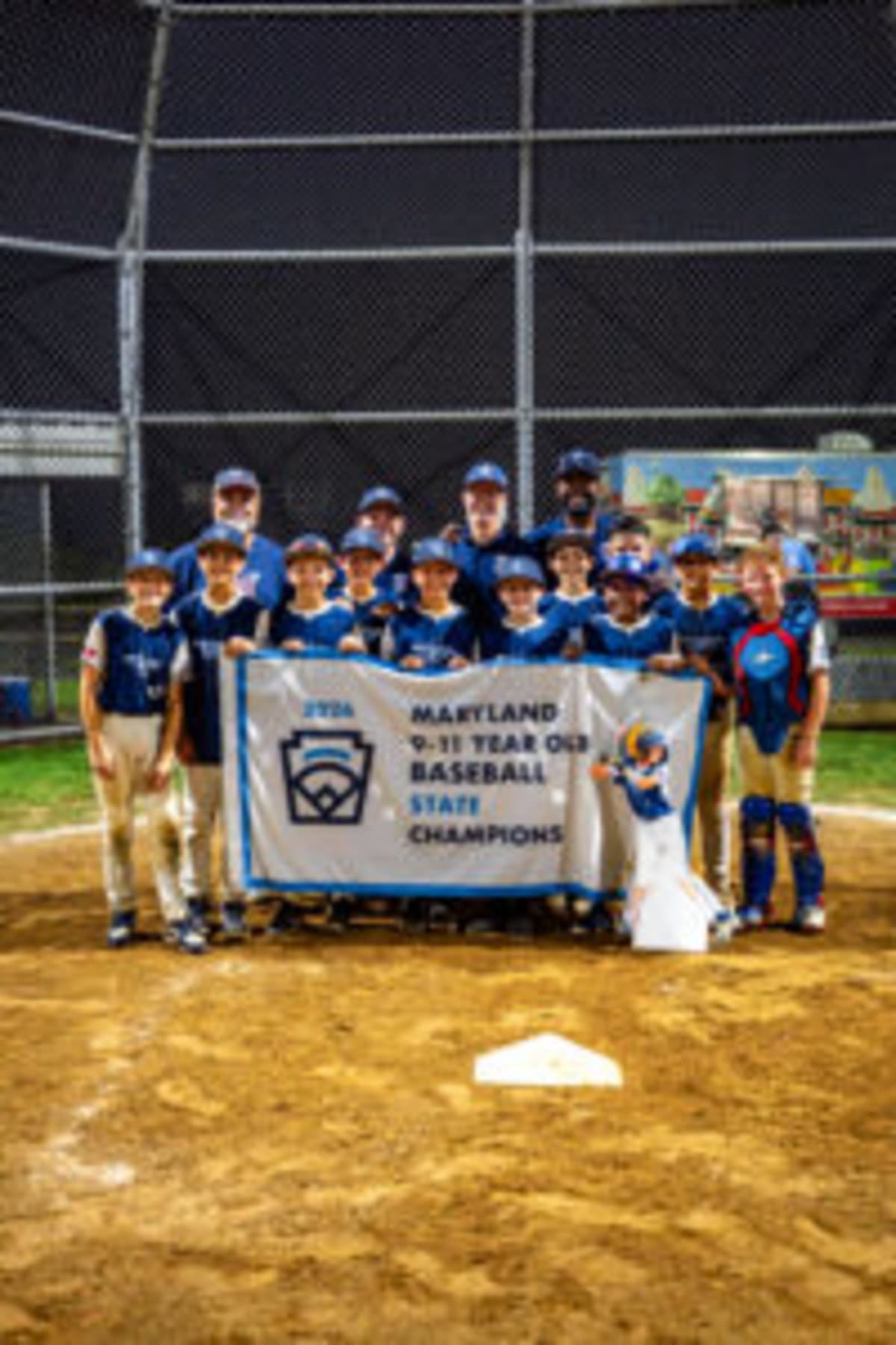 Young baseball players in Little League uniforms celebrating together after winning Maryland state championship